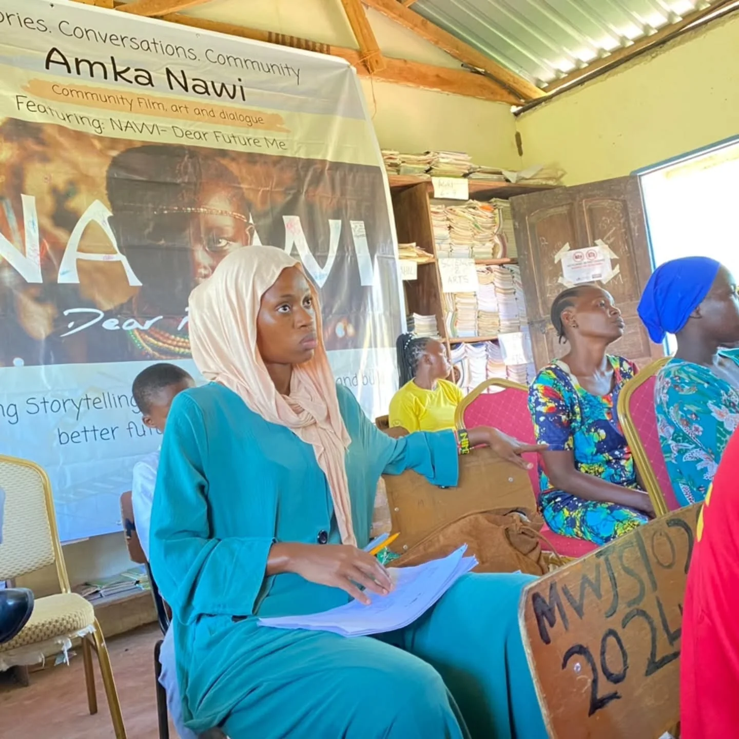 Women and girls take part in a reflective Amka Nawi village conversation.
