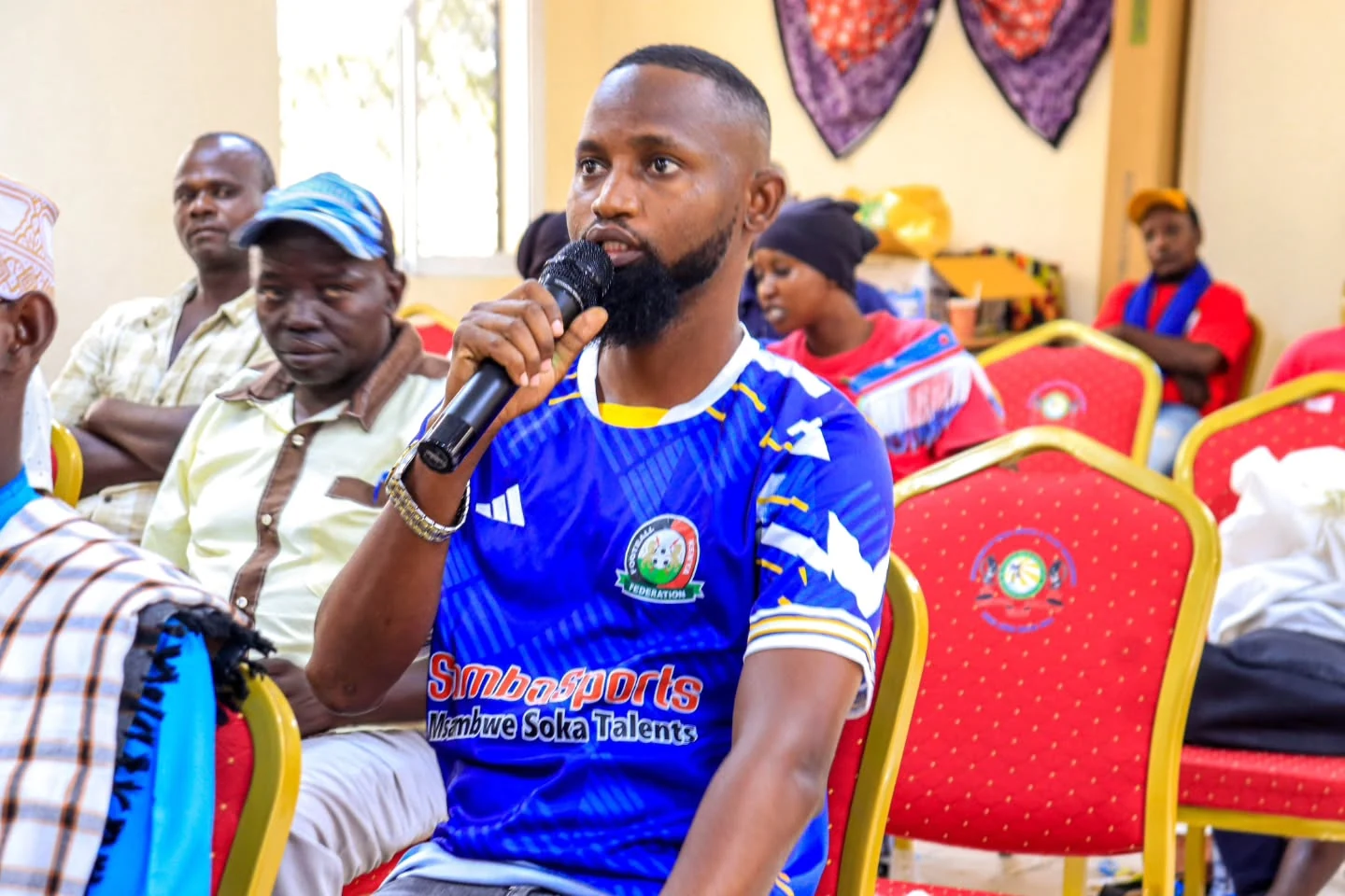 A participant speaks into a microphone during an Amka Nawi dialogue.