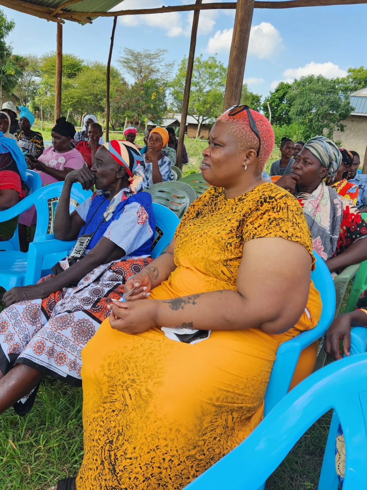 Parents and caregivers gather outdoors for an L-Care community dialogue.
